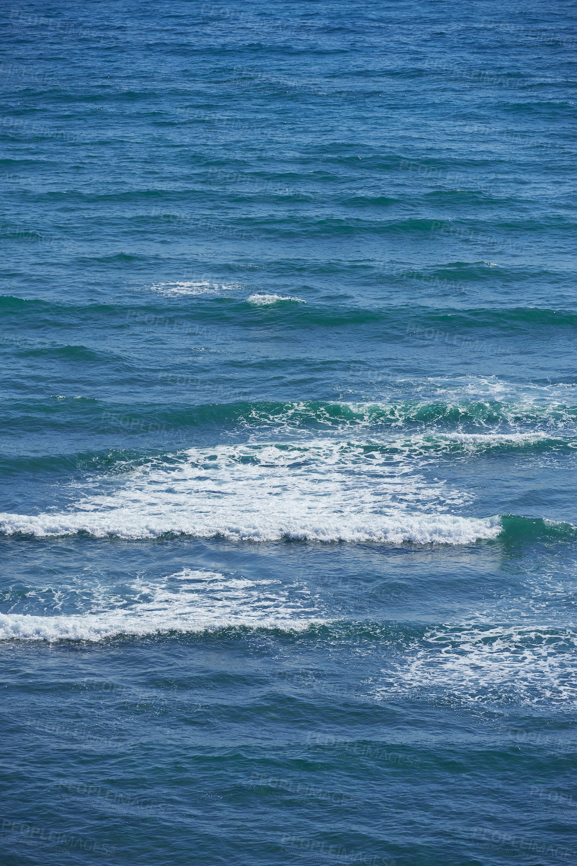 Buy stock photo Calm waves in the empty ocean on a sunny day. Beautiful sea water with light ripple effects on the surface. Abstract aqua textures in the deep wide sea. White foam patterns in the Atlantic or pacific