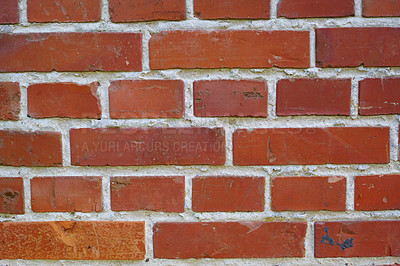 Buy stock photo Closeup of a brick wall with cement and rough texture on a home or house. Details of modern architecture on of a residence or building as a background. Solid red brickwork on a wall