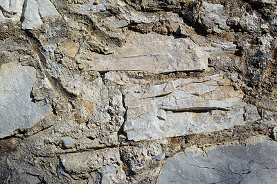 Buy stock photo Closeup of ancient stone wall Background of rustic, rural building and masonry. Historic housing design concept of an urban structure outside with copyspace. Detail of antique architecture in village