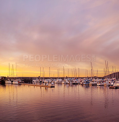 Buy stock photo Sail boats at a habor in a lake with a sunset in the background on a cloudy day. Parked yachts at a fishing port with a beautiful scenic view. Fisherman boats parked at sunrise in the morning