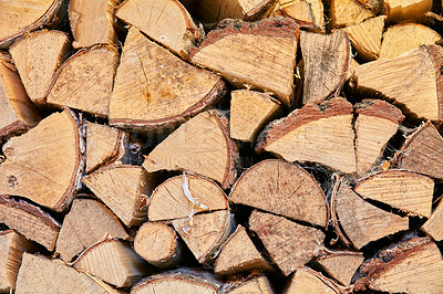 Buy stock photo Wood chopped up and stacked into a storage pile. Collecting firewood as a source of energy. Different sizes and shapes of logs after felling, materials for tools and shelter from above