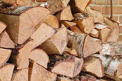 Buy stock photo View of chopped firewood, logs stacked together in storage pile with copyspace. Closeup of wooden background and texture. Collecting dry rustic hardwood as a source of energy or to keep warm