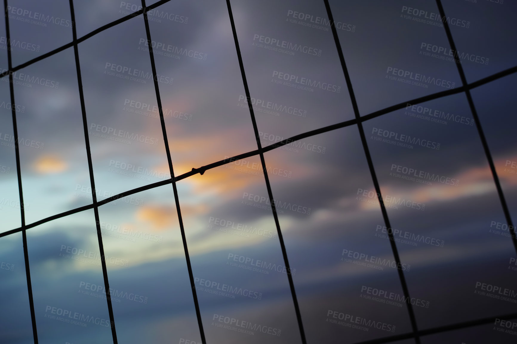 Buy stock photo Closeup of a wire fence at sunset. Background of vertical and horizontal lines. Silhouette of wire mesh in rectangle shapes for security concept. 