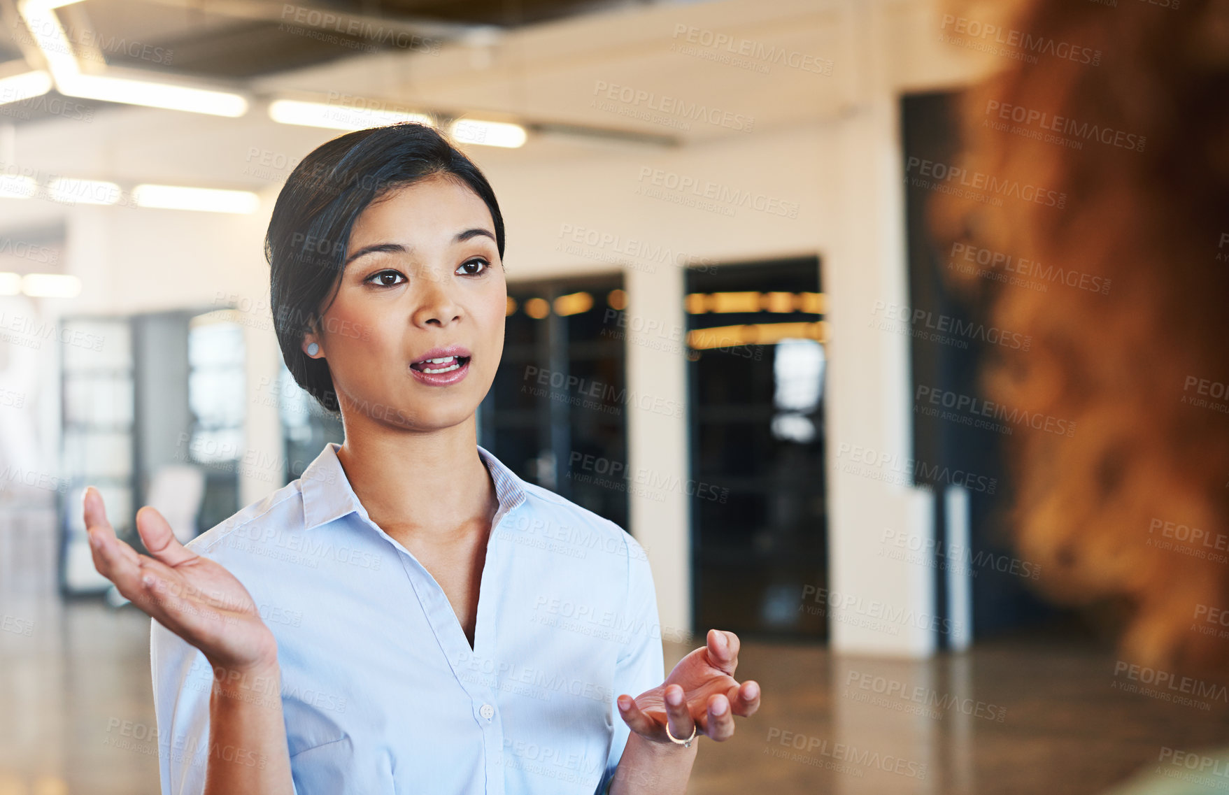 Buy stock photo Shot of two businesswoman talking together in an office