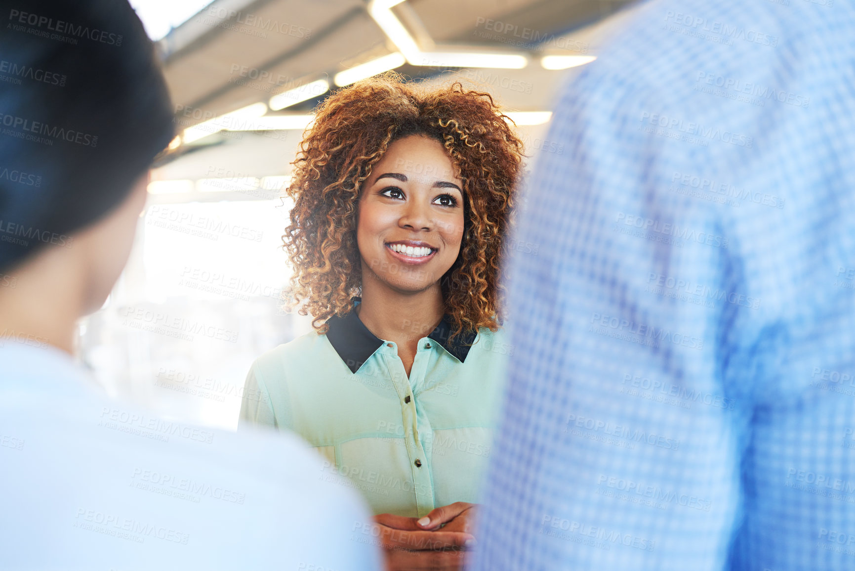 Buy stock photo Talking, discussion and happy business people in a meeting for planning, strategy and collaboration. Smile, teamwork and black woman in conversation with employees about an idea, plan or partnership