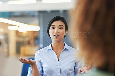 Buy stock photo Shot of a coworkers talking together in an office
