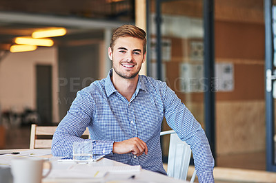 Buy stock photo Portrait of a successful young businessman working in an office
