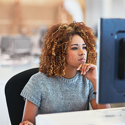 Buy stock photo Shot of a young businesswoman using a computer in an office