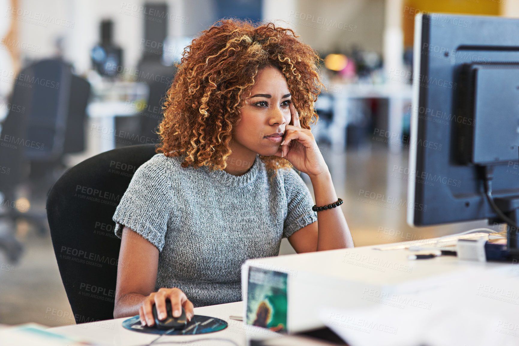 Buy stock photo Shot of a young businesswoman using a computer in an office