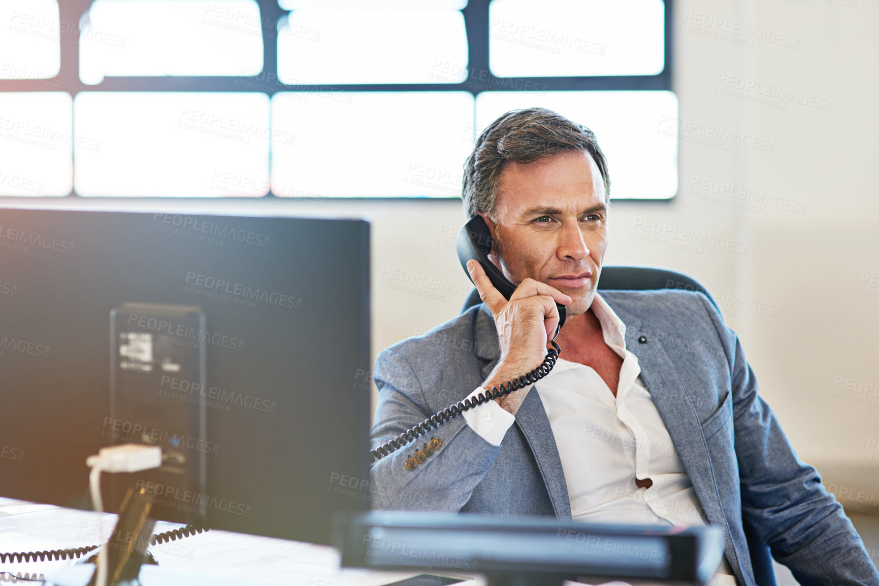 Buy stock photo Telephone, office and man on a business call for a corporate company deal, sale or partnership. Phone call, professional and mature male ceo, boss or entrepreneur having a conversation in workplace.