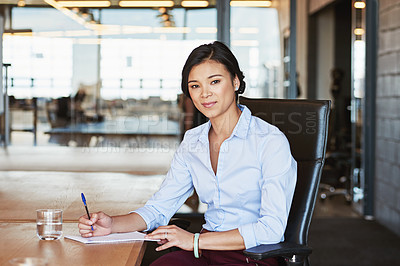 Buy stock photo Portrait of an ambitious young businesswoman working in the office