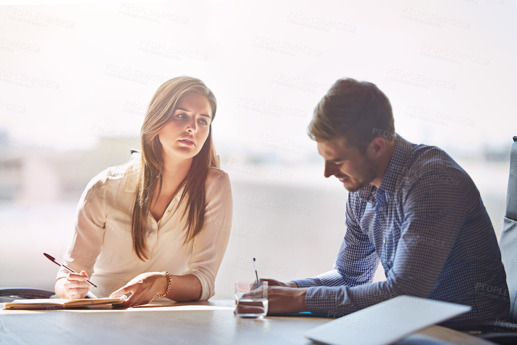 Buy stock photo Shot of two businesspeople having a meeting in a boardroom