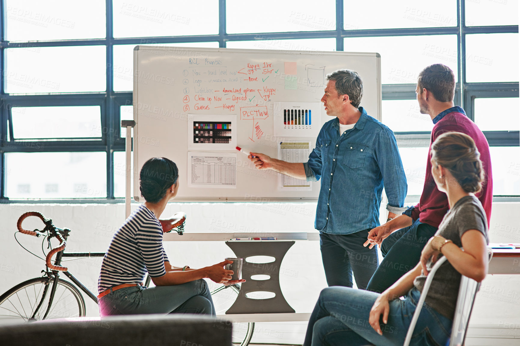 Buy stock photo Shot of designers brainstorming on a whiteboard in an office