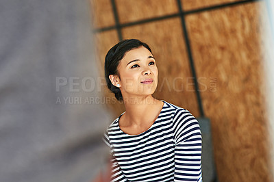 Buy stock photo Shot of a young woman sitting in an office