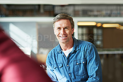 Buy stock photo Shot of a smiling man sitting in an office