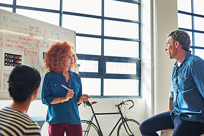 Buy stock photo Marketing, planning and employees brainstorming in a meeting for a strategy, goal and idea. Presentation, teamwork and creative woman in a workshop with a team writing sales ideas on a whiteboard