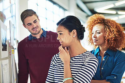 Buy stock photo Business people, board and thinking in office with focus, learning or strategy for teamwork success. Group diversity, women and businessman reading whiteboard for marketing, team building or planning