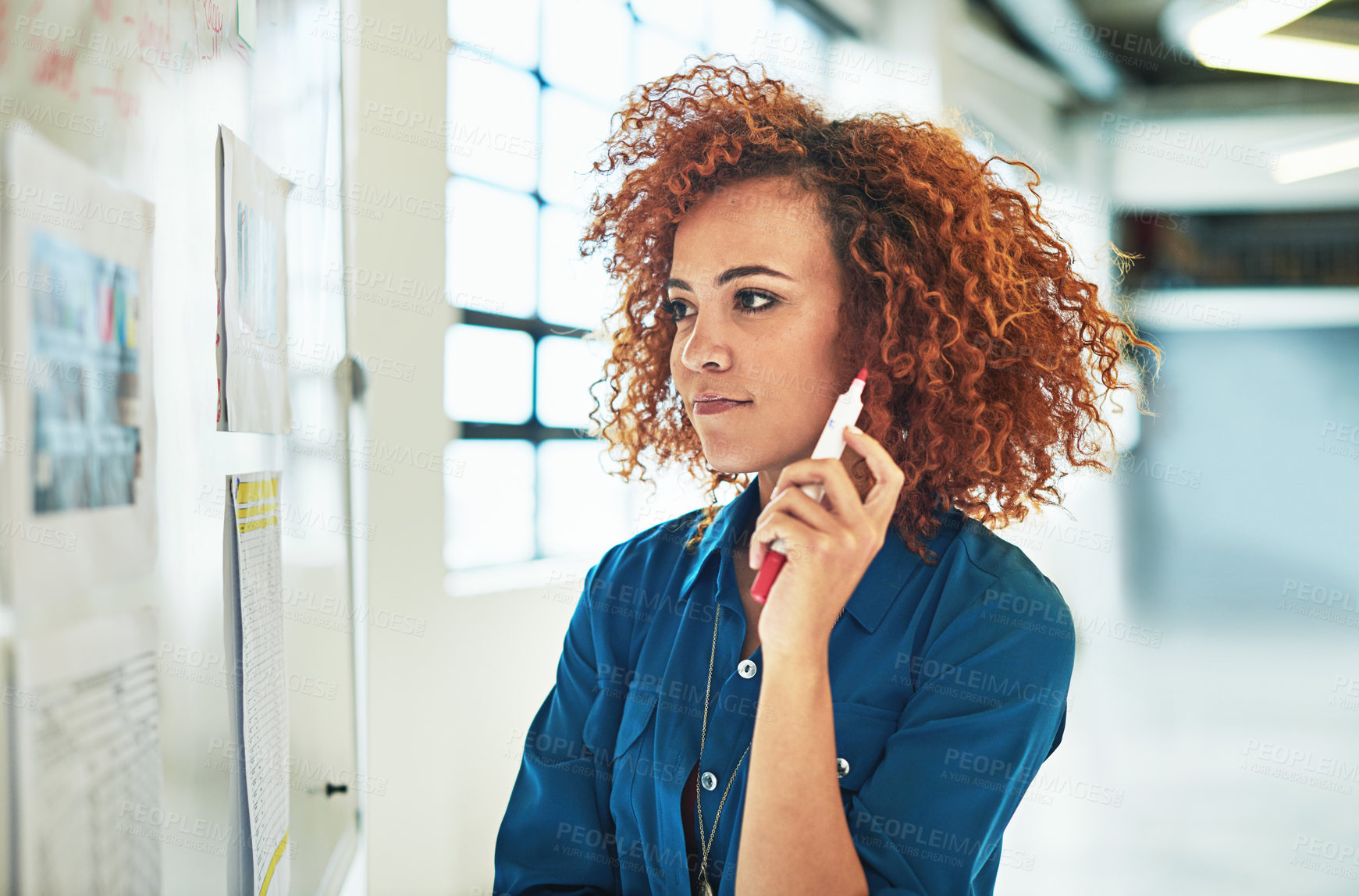 Buy stock photo Shot of a designer brainstorming on a whiteboard in an office