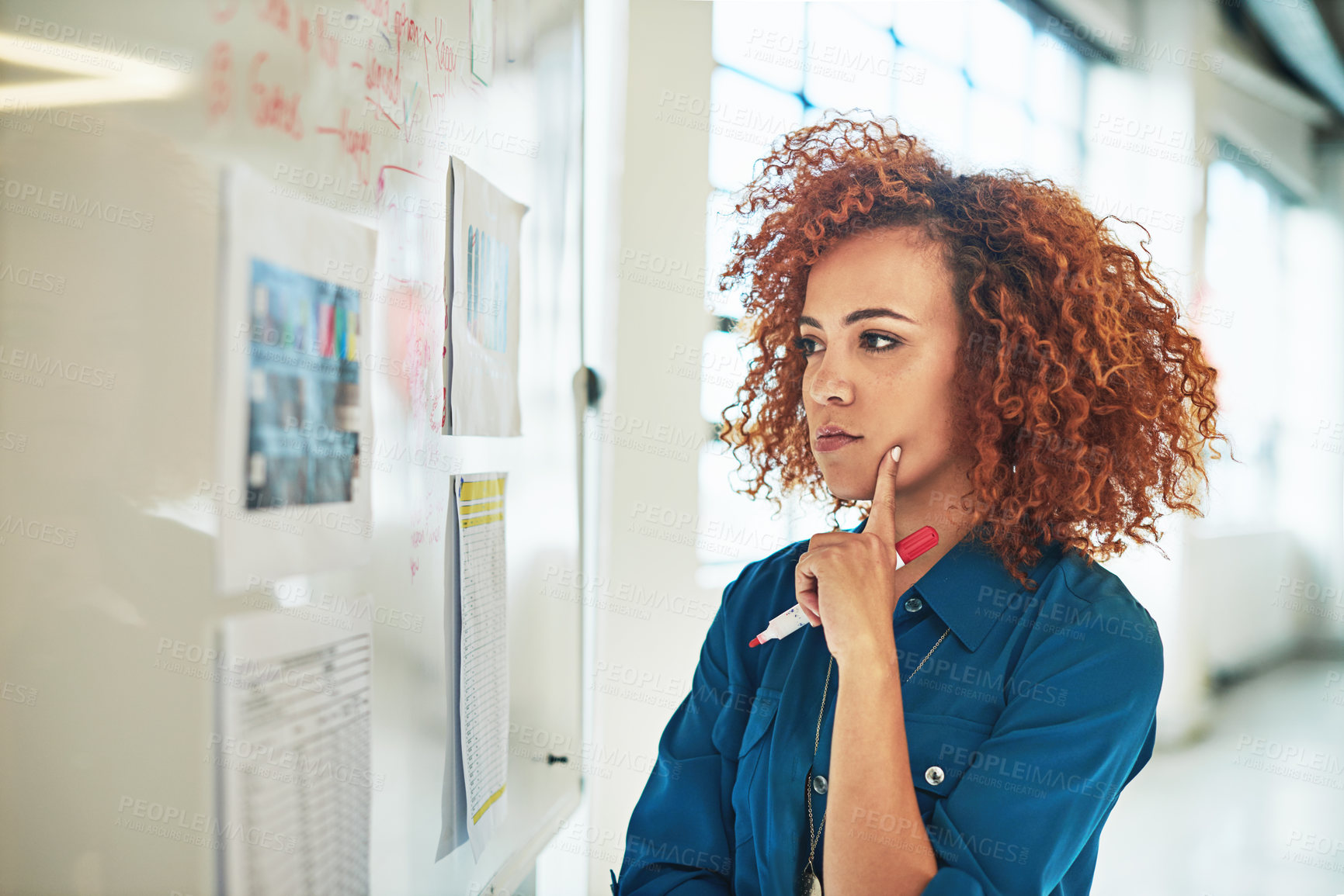 Buy stock photo Shot of a designer brainstorming on a whiteboard in an office