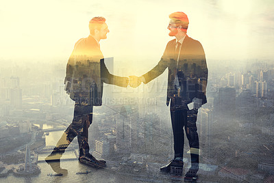 Buy stock photo Multiple exposure shot of a two businessmen shaking hands superimposed over a city