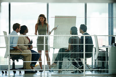 Buy stock photo Shot of a group of colleagues brainstorming in an office