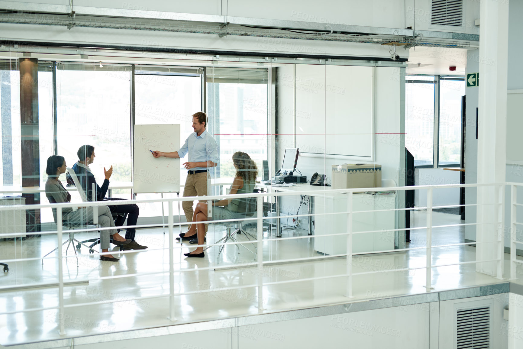 Buy stock photo Shot of a group of colleagues brainstorming in an office