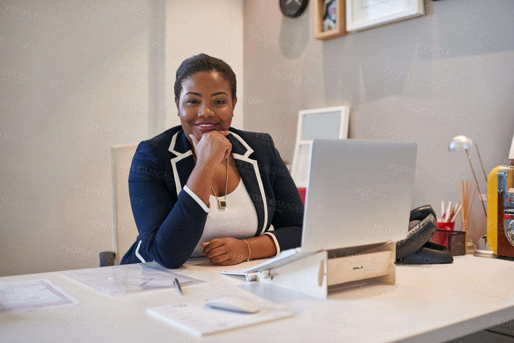 Buy stock photo Portrait of a businesswoman sitting at her desk working on a laptop