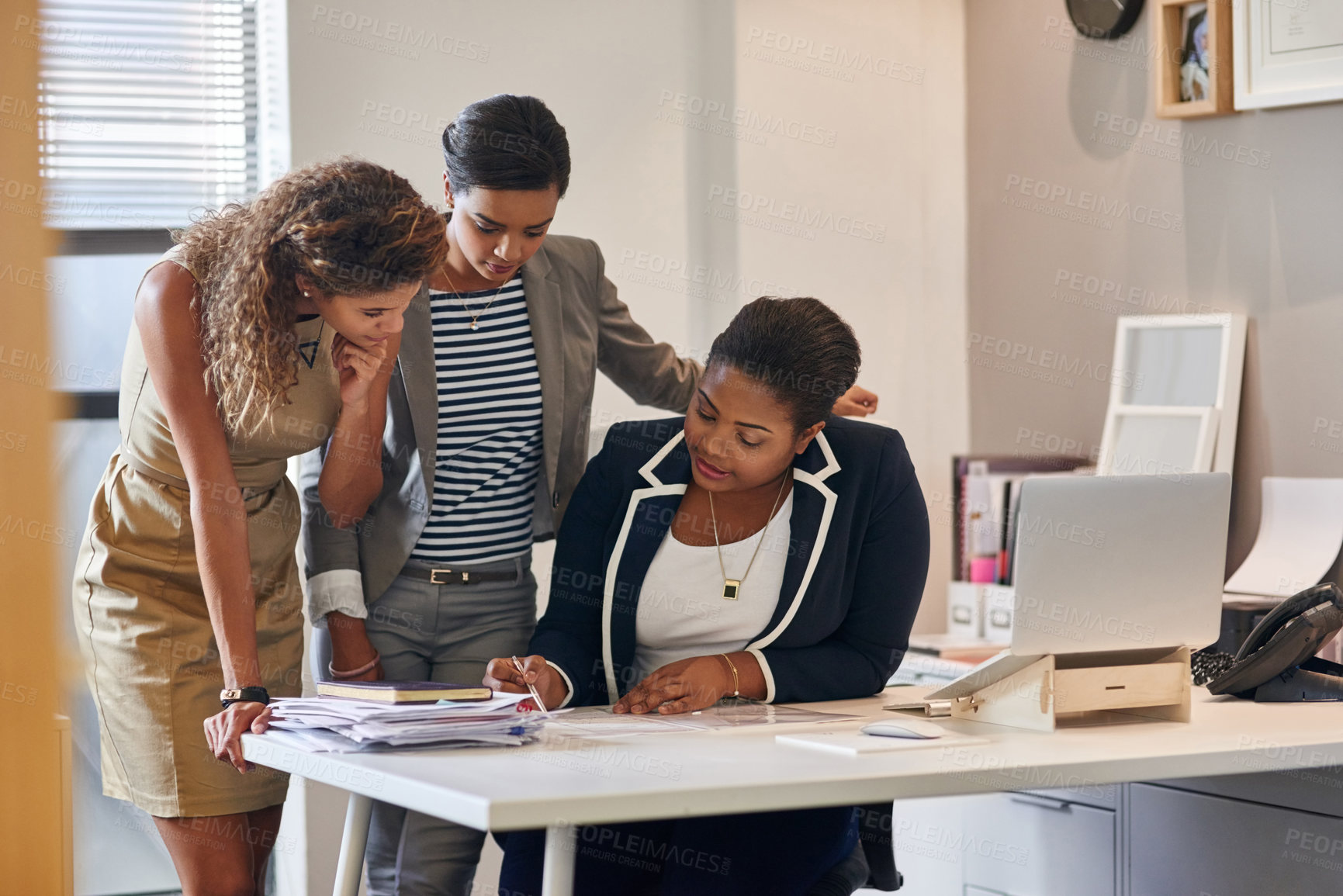 Buy stock photo Shot of a group of female colleagues talking together in an office