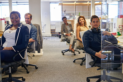 Buy stock photo Portrait of a group of colleagues sitting together in an office