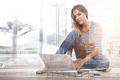 Buy stock photo Multiple exposure shot of a young woman using a laptop superimposed over a city background