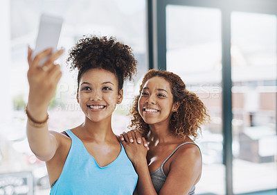Buy stock photo Cropped shot of two young women taking a selfie after yoga class