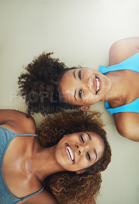Buy stock photo High angle portrait of two young women lying on the floor after yoga class