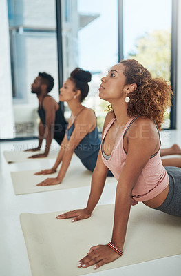 Buy stock photo Shot of a group of people doing yoga