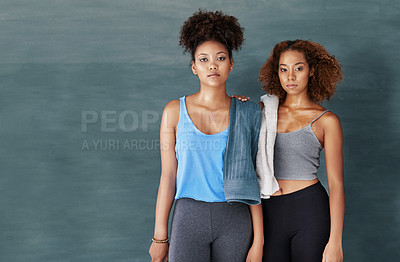 Buy stock photo Studio portrait of two young women after yoga class against a grey background