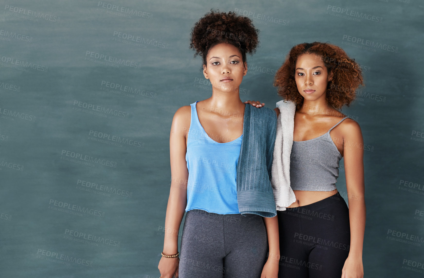 Buy stock photo Studio portrait of two young women after yoga class against a grey background