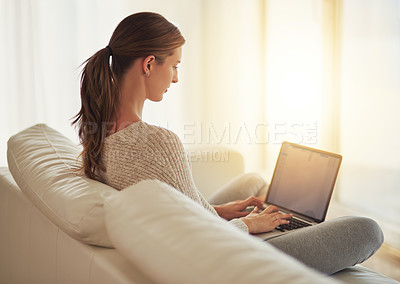 Buy stock photo Laptop, remote work and woman typing on sofa in home living room. Computer, freelancer and professional on couch in lounge writing blog, copywriting or working on project, email and internet research