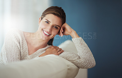 Buy stock photo Shot of a young woman relaxing on her sofa at home