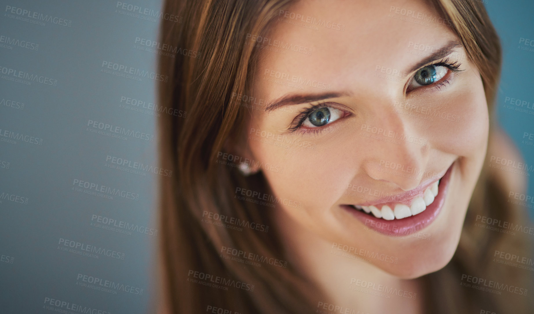 Buy stock photo High angle studio shot of an attractive young woman smiling against a gray background