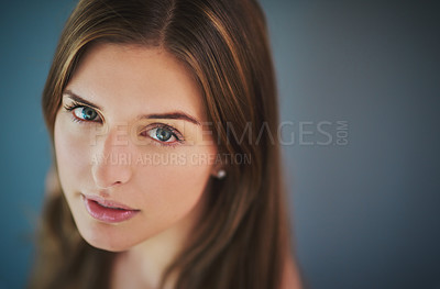 Buy stock photo High angle studio shot of an attractive young woman posing against a gray background