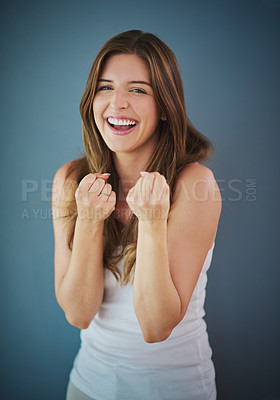 Buy stock photo Woman, fashion and happy with fist in studio with comfort wear, clothes and style on isolated gray background. Female person, portrait and smile or satisfied in confidence with casual outfit