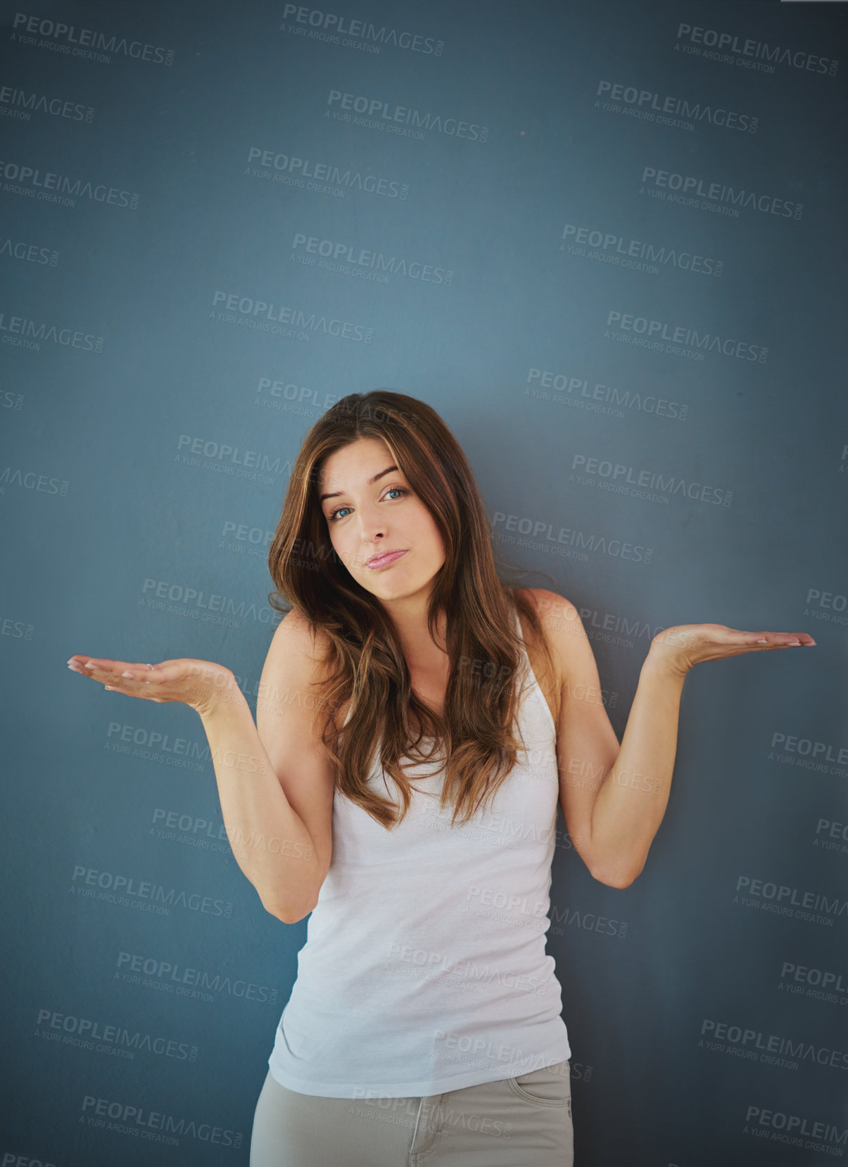 Buy stock photo Studio portrait of a confident young woman posing against a gray background