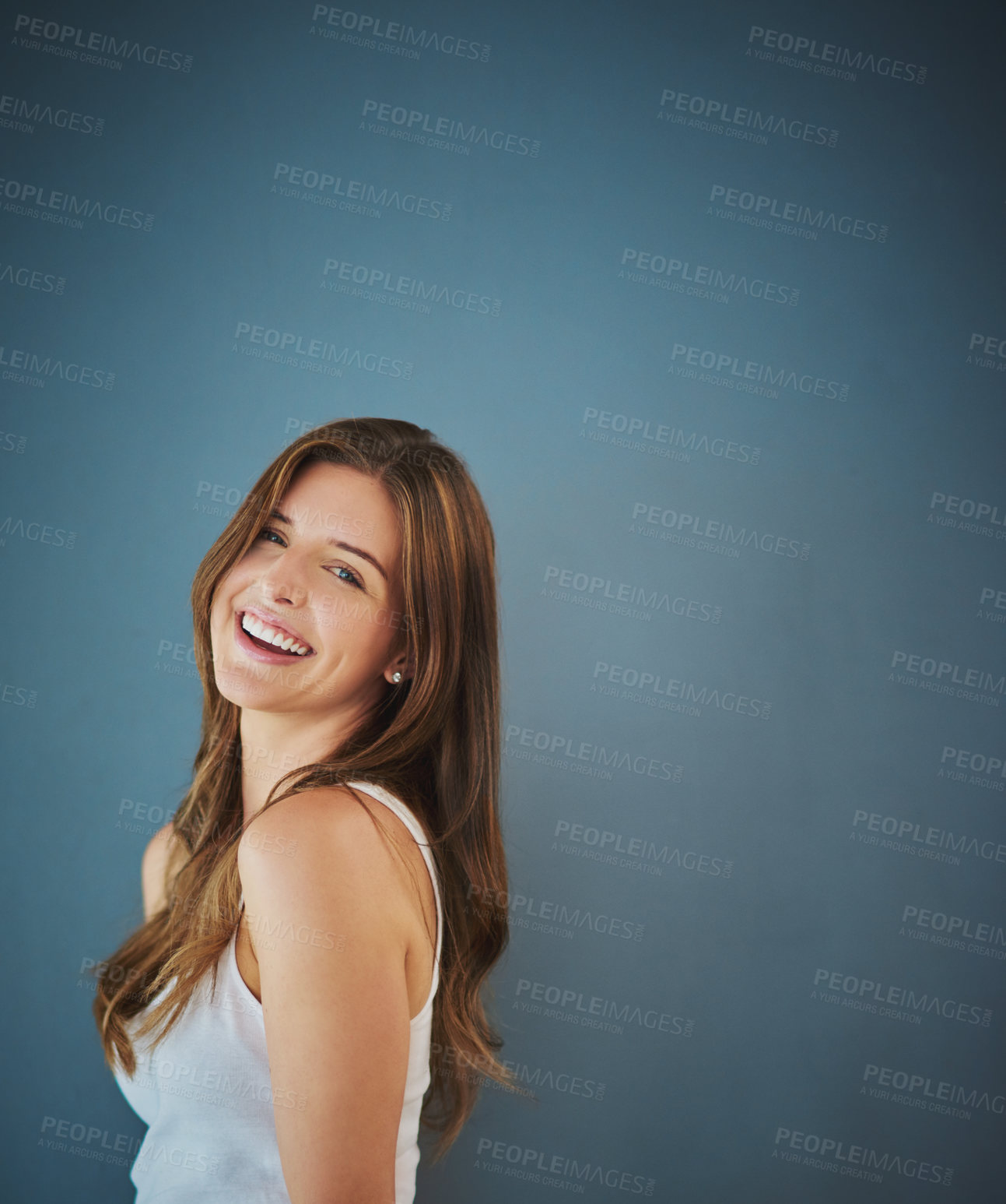 Buy stock photo Studio portrait of an attractive young woman posing against a gray background