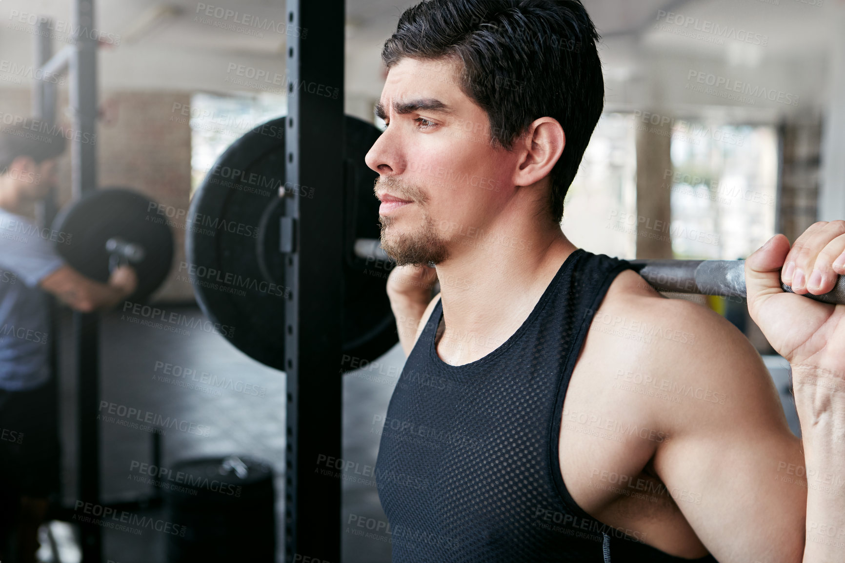 Buy stock photo Shot of a young athlete working out in the gym