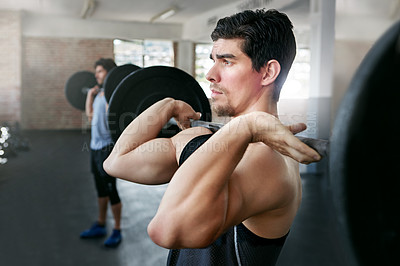 Buy stock photo Shot of young men working out with weights in the gym