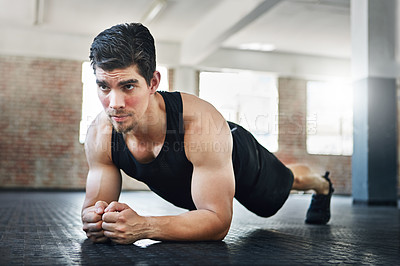 Buy stock photo Shot of a young athlete working out in the gym