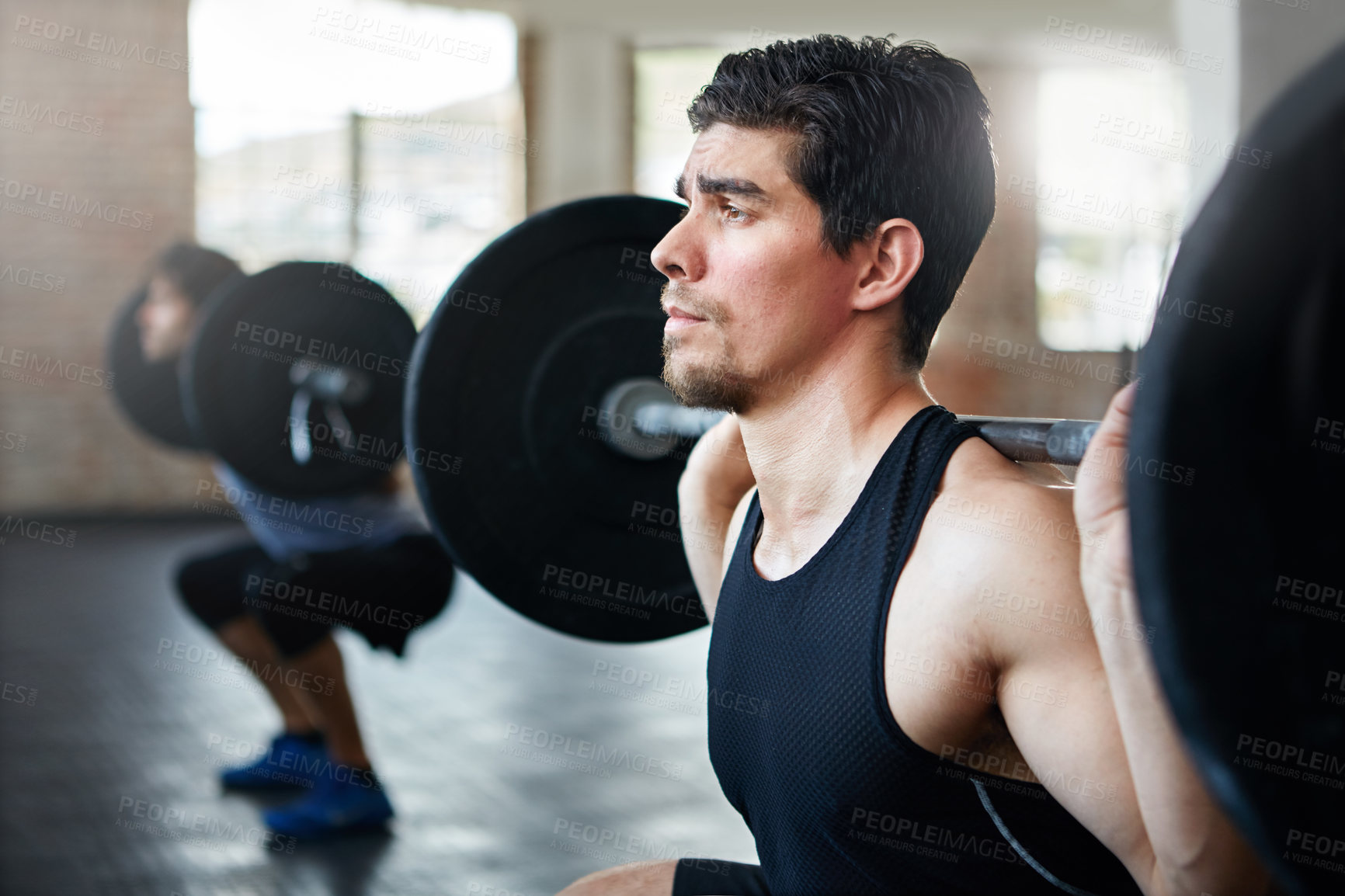 Buy stock photo Shot of young men working out with weights in the gym