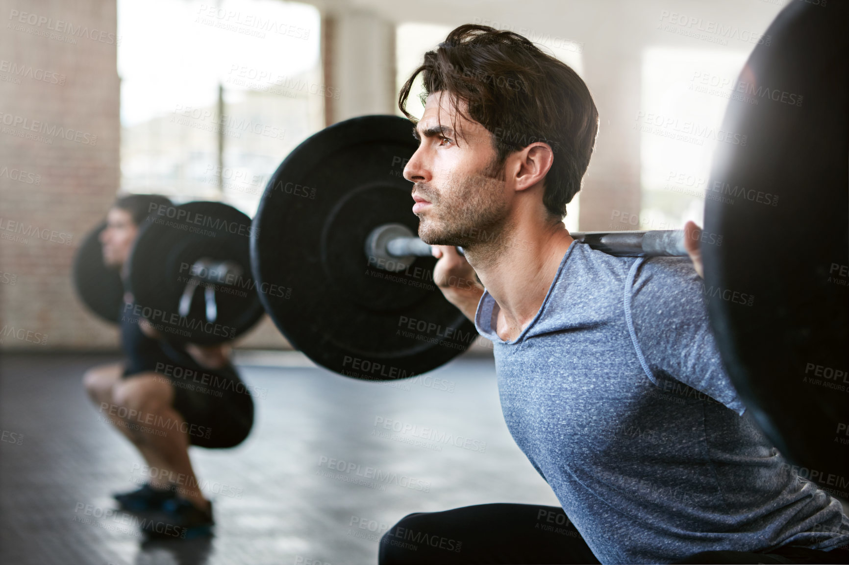 Buy stock photo Shot of young men working out with weights in the gym