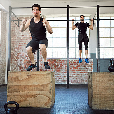 Buy stock photo Shot of a young men working out in the gym