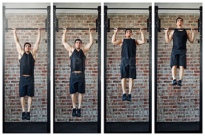 Buy stock photo Shot of a young man doing pull ups in a gym