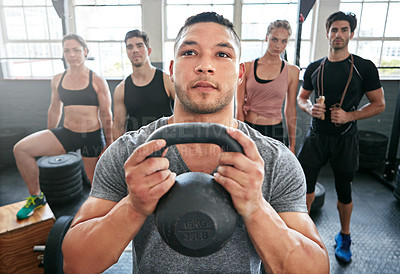 Buy stock photo Portrait of a fit young man standing in a gym with people in the background